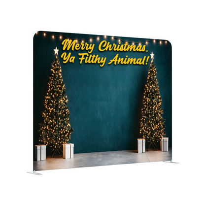 Christmas-themed backdrop with trees and text 'Merry Christmas, Ya Filthy Animal!' on a teal background.