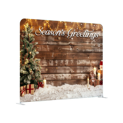 Christmas-themed backdrop with 'Season's Greetings' text, decorated with a tree, presents, and lights.