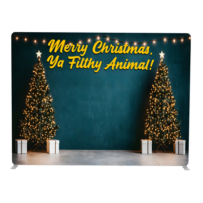 Christmas-themed backdrop with two decorated trees and a humorous Christmas message.
